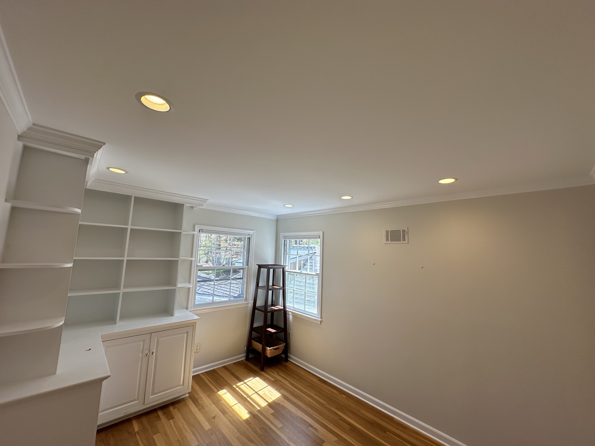Freshly painted built-in shelving with crown molding by J&B Painting