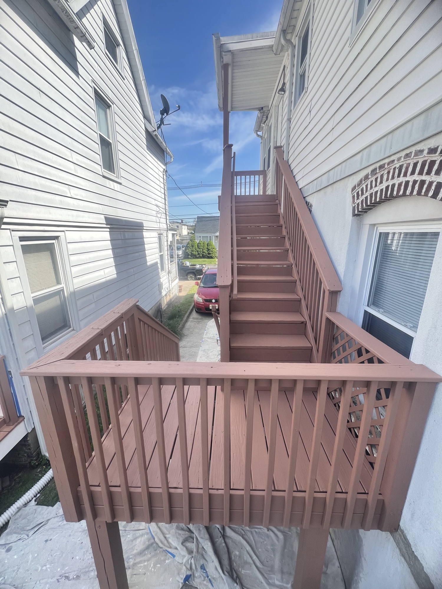 Brown stained deck stairs and railings by J&B Painting