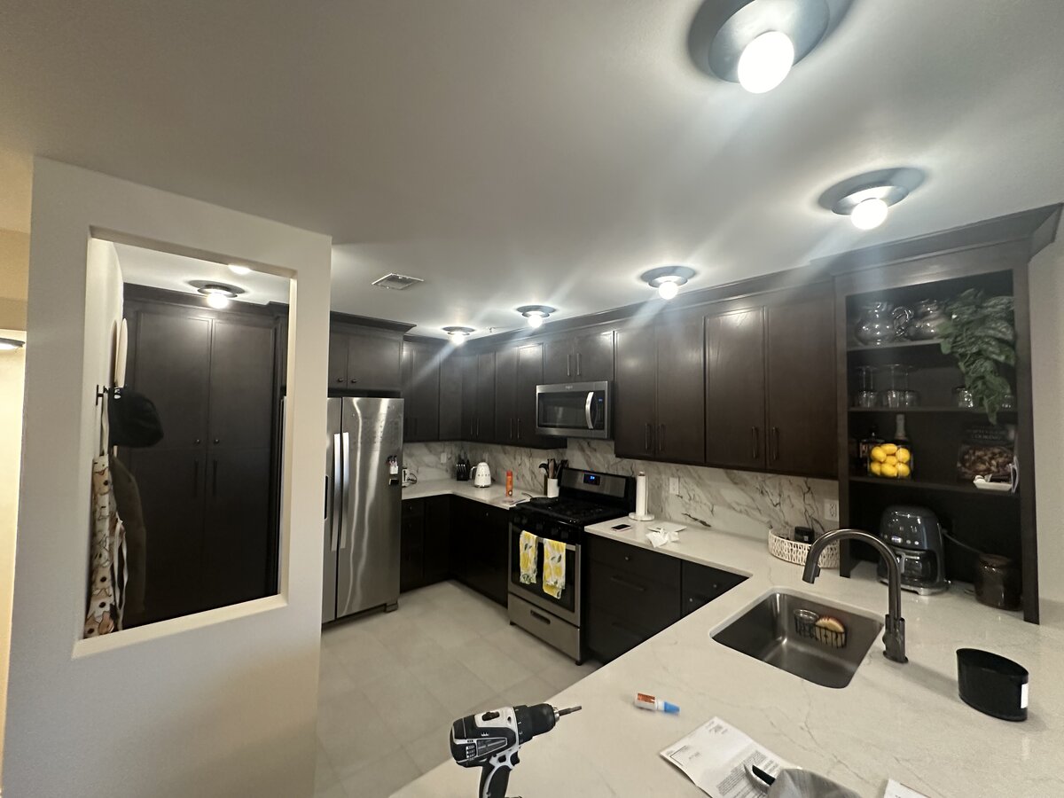 Dark espresso kitchen cabinet refinishing with marble countertops by J&B Painting