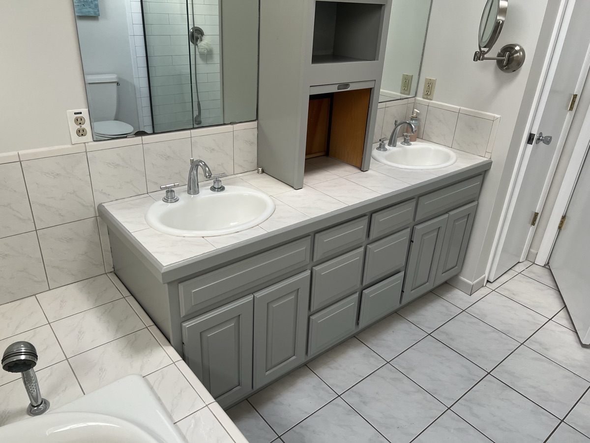 Gray painted bathroom vanity with double sinks by J&B Painting