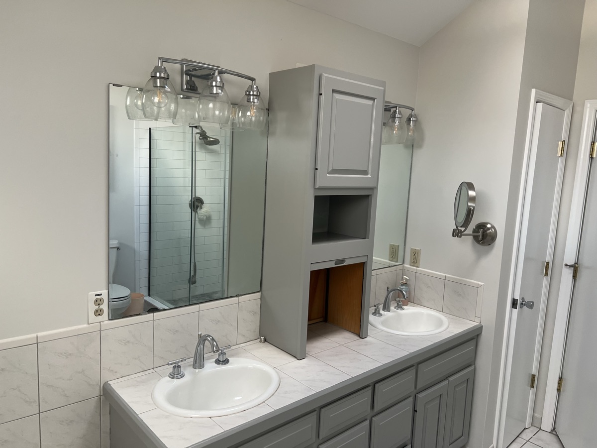 Refinished bathroom vanity wide angle with vanity lighting by J&B Painting
