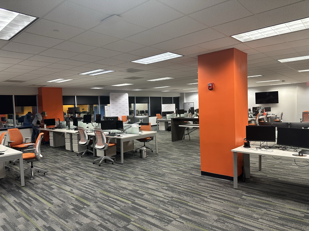 Open office with orange accent columns and workstations by J&B Painting