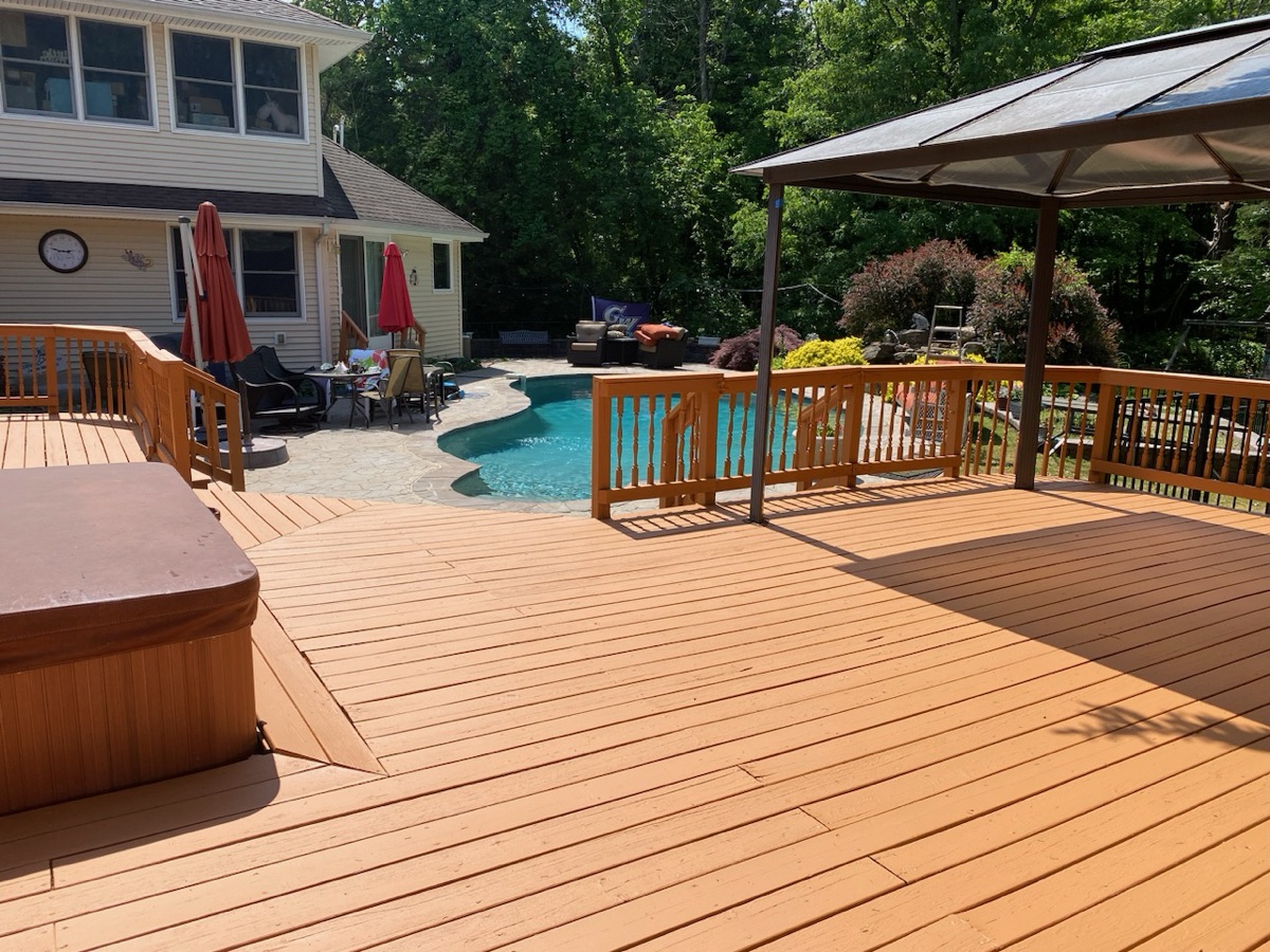 Beautifully stained poolside deck after refinishing by J&B Painting