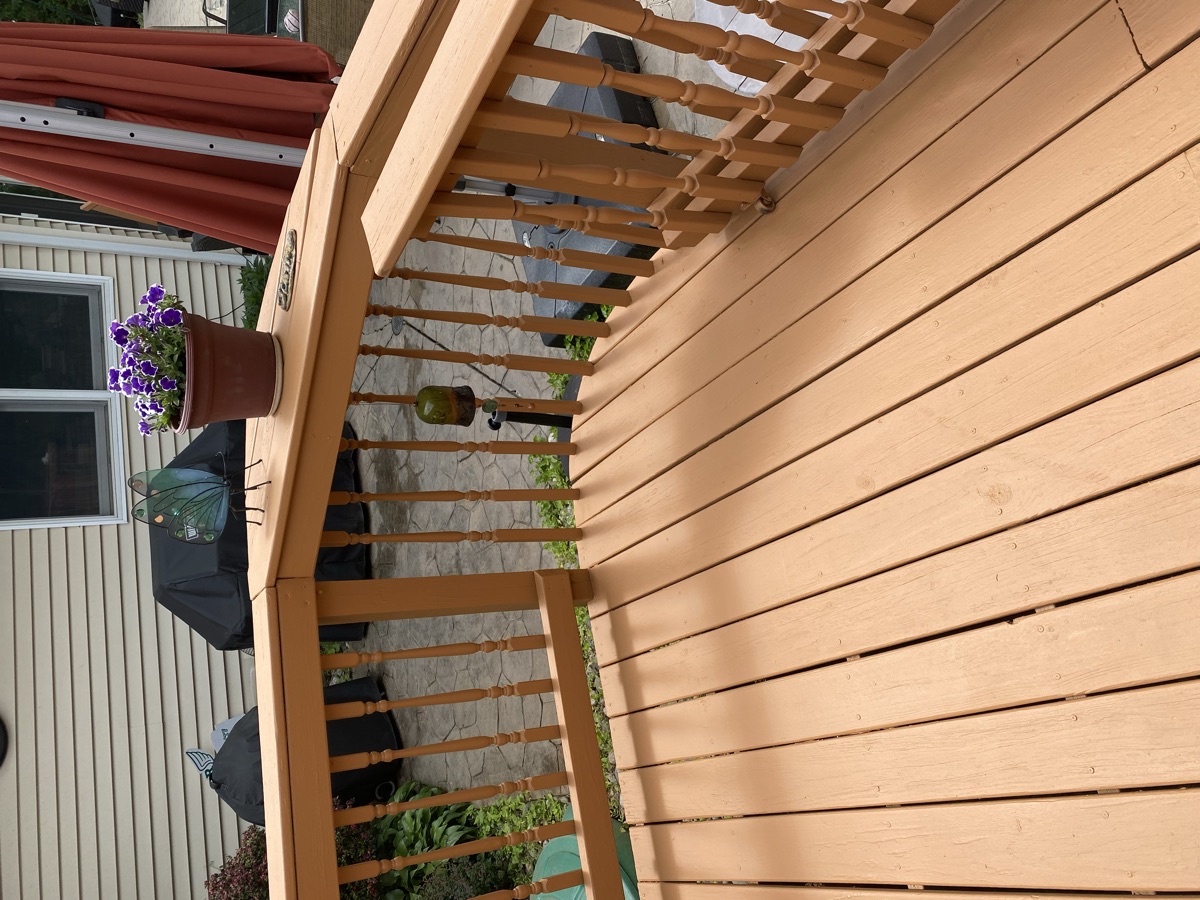 Stained wood pergola and deck with planters by J&B Painting