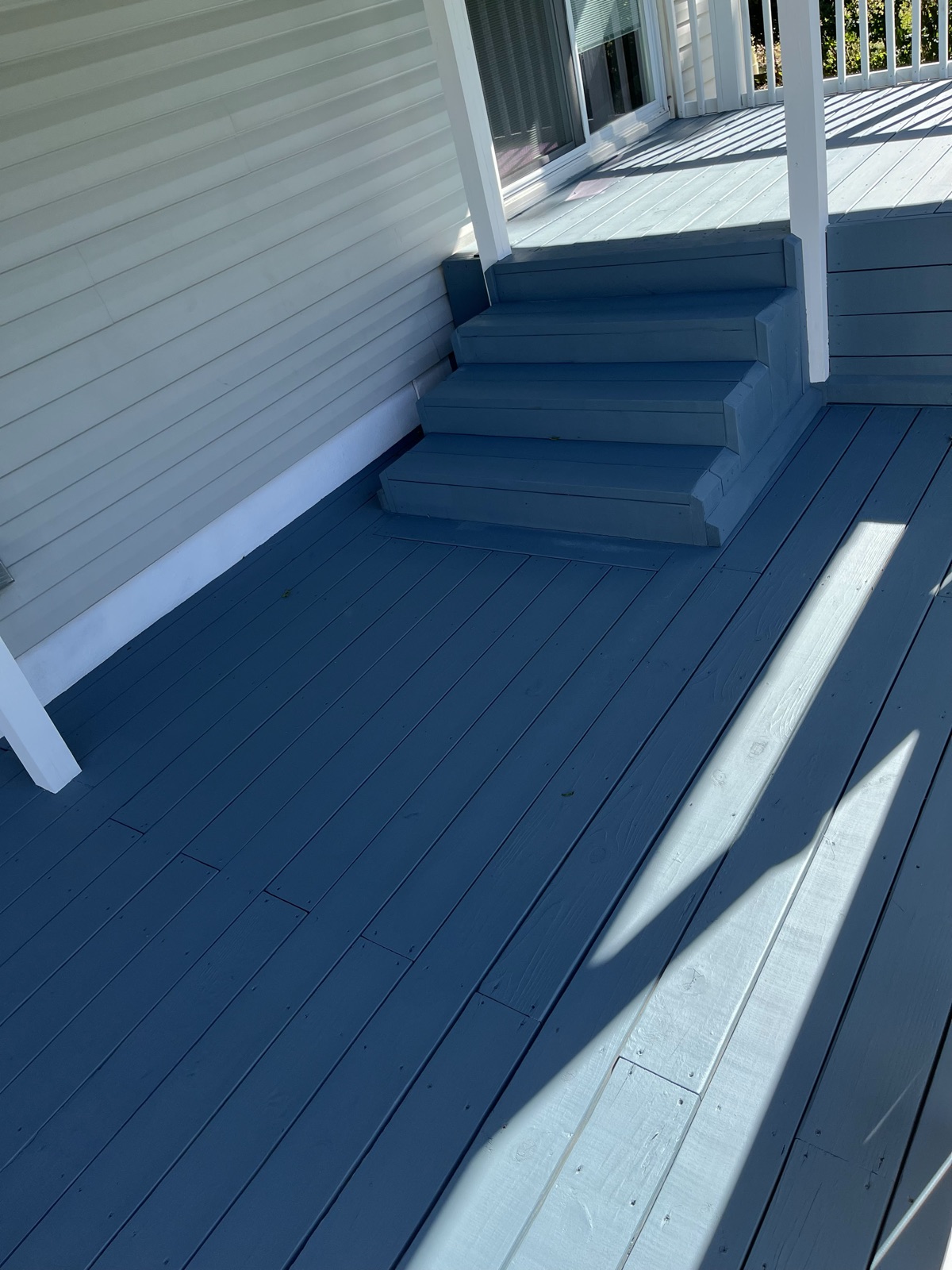 Blue painted porch steps with white trim by J&B Painting