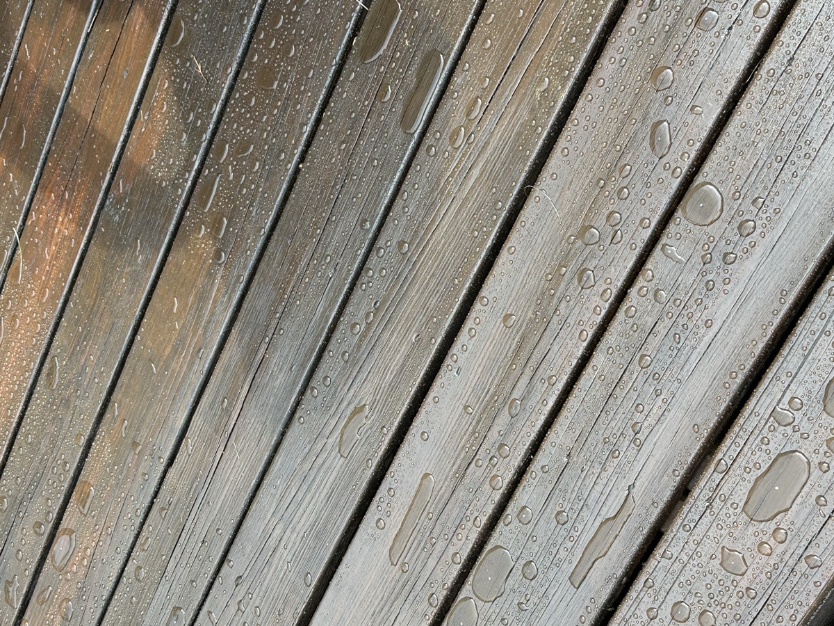 Water beading on freshly sealed deck surface by J&B Painting