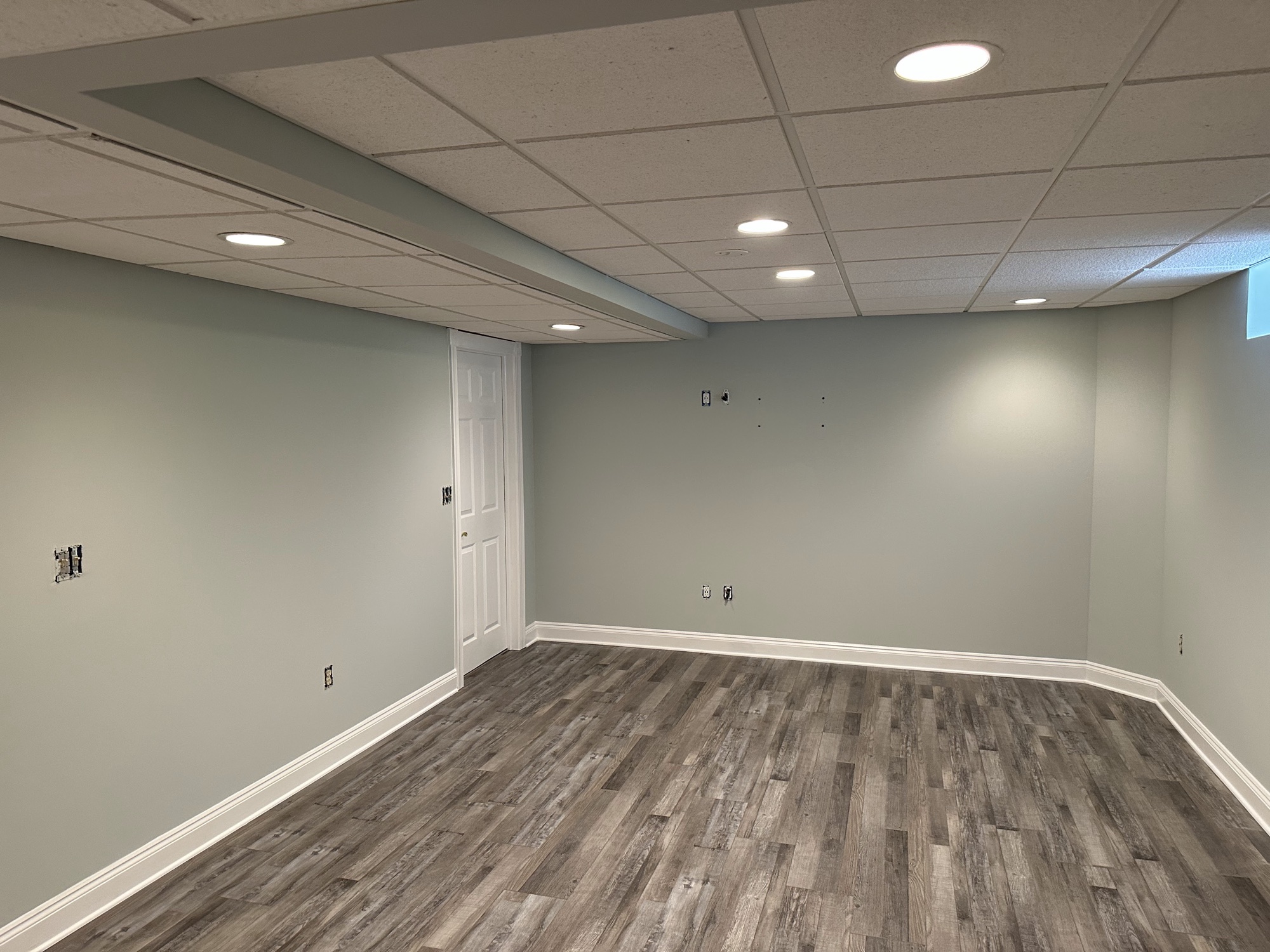 Sage green basement walls with white trim by J&B Painting