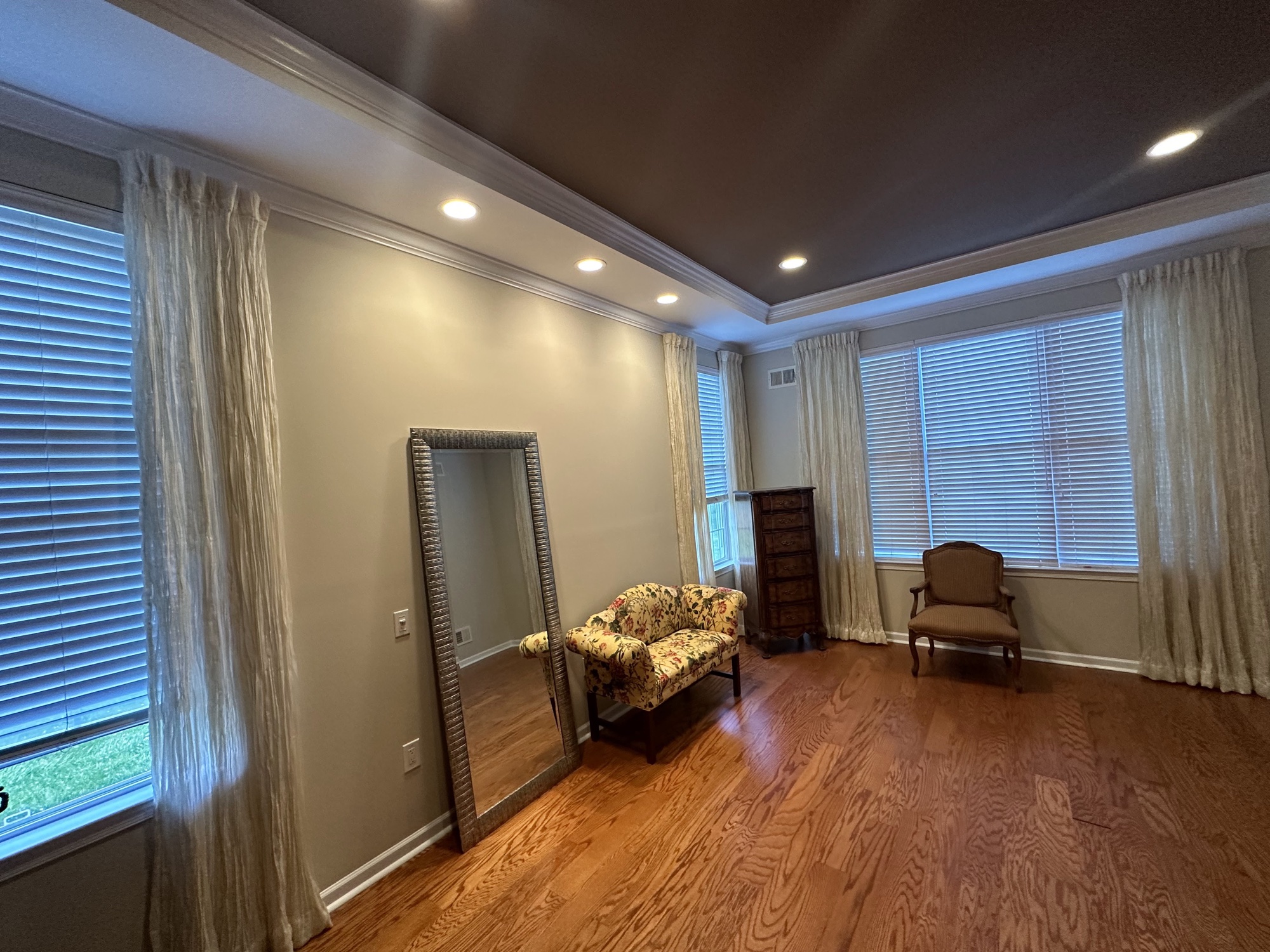 Dark tray ceiling with neutral walls and crown molding by J&B Painting