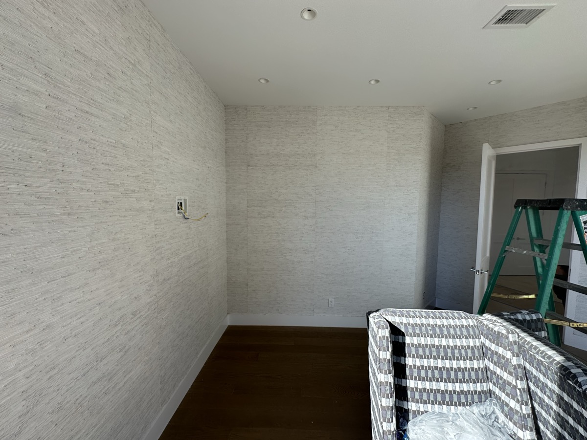 Textured neutral wallpaper installation